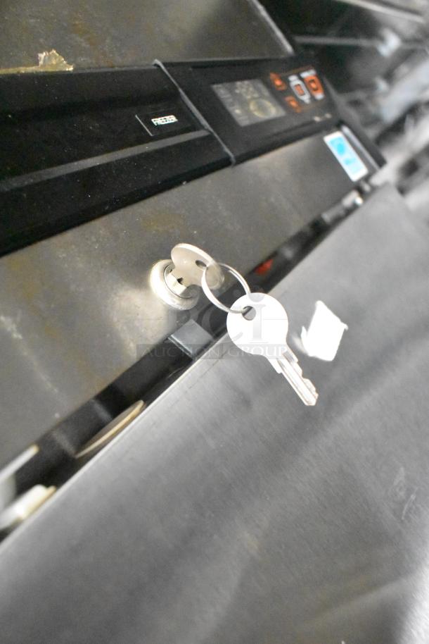 2021 Diamond Cargo 8.5' x 24' cold food and beverage trailer key in ignition, highlighting security feature.