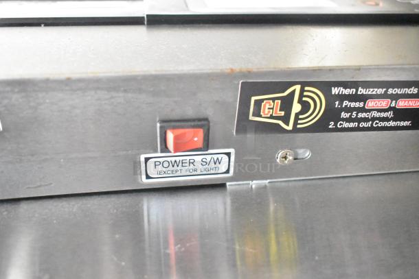 Power switch and instruction labels inside Diamond Cargo 2021 8.5' x 24' trailer, indicating condenser maintenance steps.