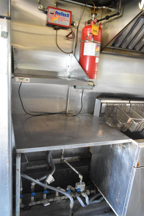 2019 Quality Cargo 24ft food trailer interior with gas cooking line, fire suppression system, and refrigeration units; restoration needed.