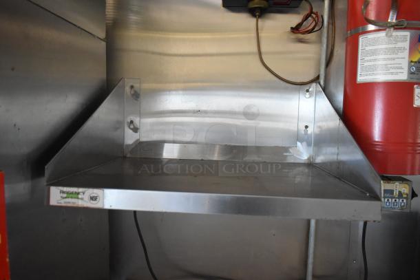 2019 Quality Cargo 24ft food trailer interior with Regency metal shelf, NSF label. Visible wires and extinguisher, restoration needed.