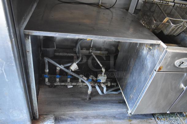 2019 Quality Cargo 24ft food trailer interior showing piping and Royal Range gas cooking equipment, needs restoration.