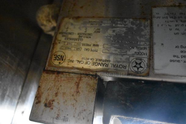NSF label on Royal Range gas cooking unit inside 2019 Quality Cargo 24ft food trailer. Signs of rust and wear.