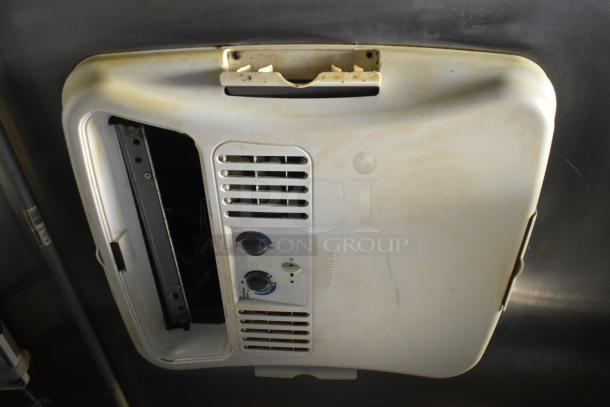 Ceiling vent unit inside the 2019 Quality Cargo 24ft food trailer, showing visible wear and controls.