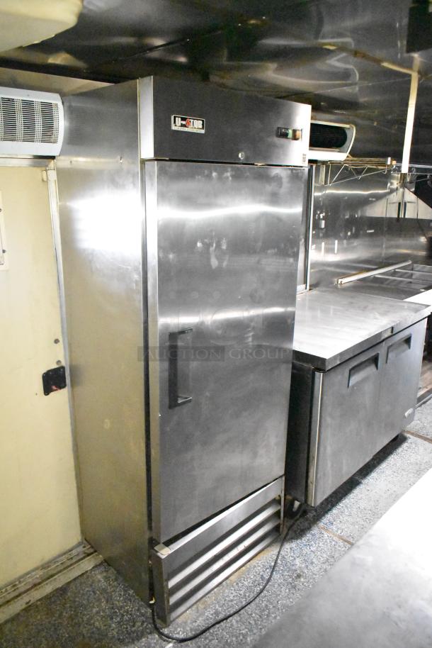 2019 Quality Cargo 24ft food trailer interior, showcasing U-Star refrigeration unit, stainless steel counters, and cooking equipment.