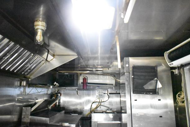 2019 Quality Cargo 24ft food trailer interior, featuring grease hood, Royal Range griddle, fryer, refrigeration units.