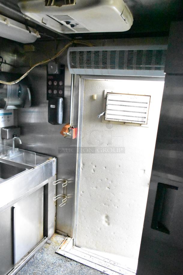 Interior of 2019 Quality Cargo 24ft food trailer with stainless steel sink, air unit, and markings indicating system controls.