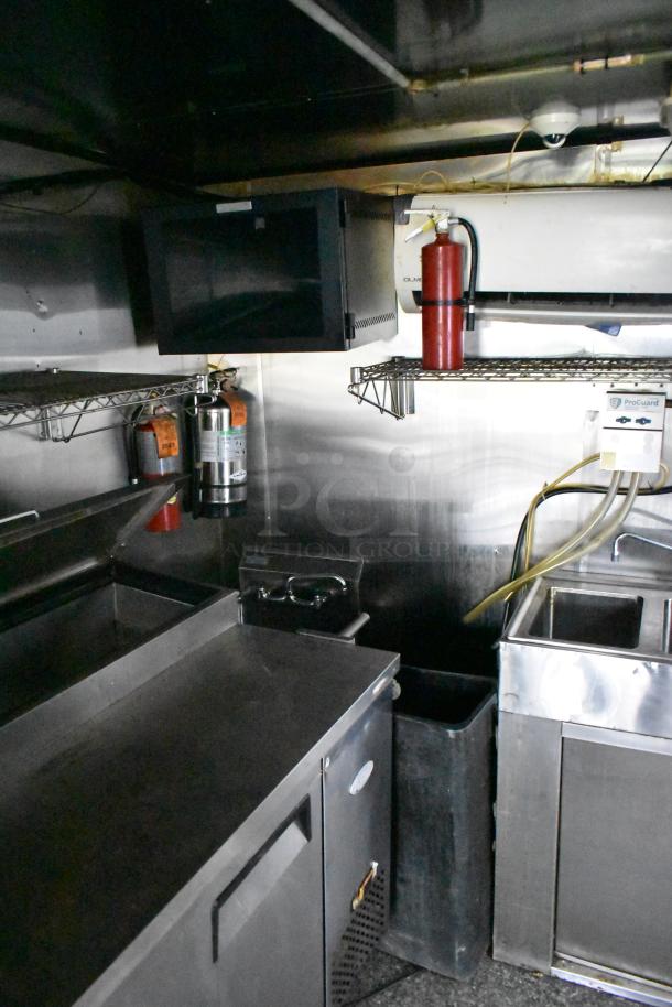 2019 Quality Cargo 24ft food trailer interior with Royal Range griddle, fryer, grease hood, and refrigeration. Clean condition.