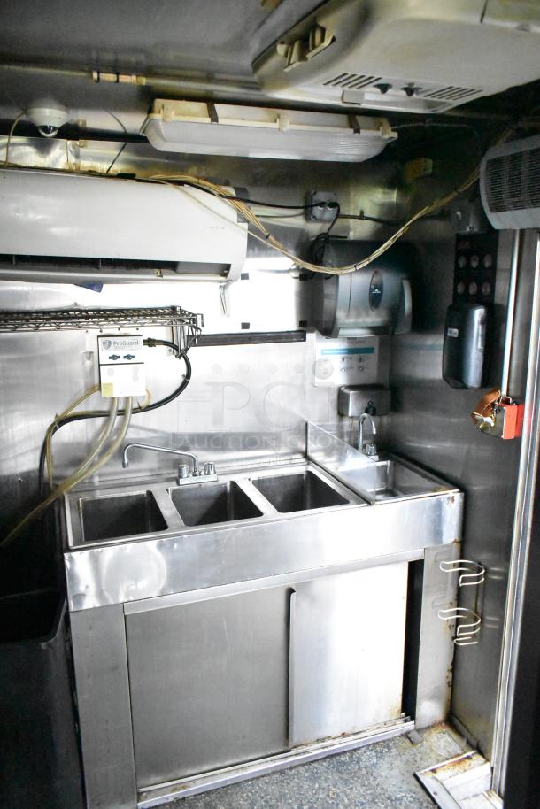 2019 Quality Cargo 24ft food trailer interior with grease hood, Royal Range Griddle, Royal Gas Fryer, refrigeration system.