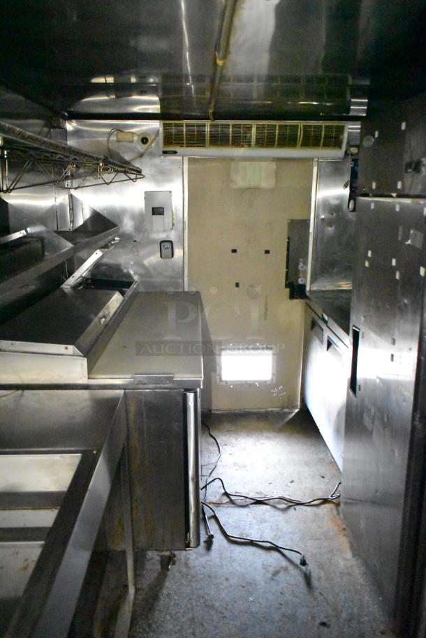 2019 Quality Cargo 24ft food trailer interior with grease hood, Royal Range griddle, fryer, and refrigeration units.