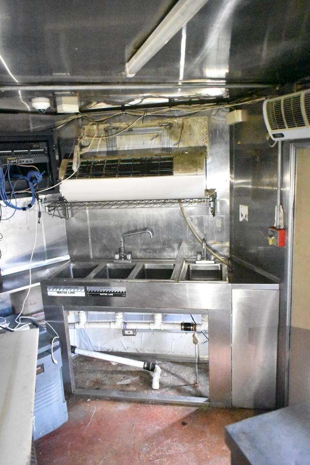 2019 Quality Cargo 24' food trailer interior, featuring a stainless steel sink area, visible water lines, and wiring.