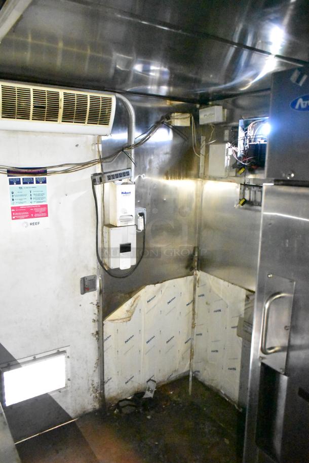 2019 Quality Cargo 24' food trailer interior, showing stainless steel walls, electrical components, and cooling system.