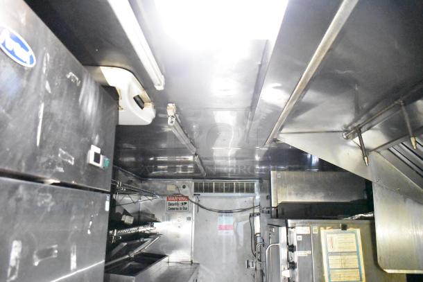 2019 Quality Cargo 24' food trailer interior featuring grease hood, fryer, grill, pizza prep with Blodgett oven, and signage.