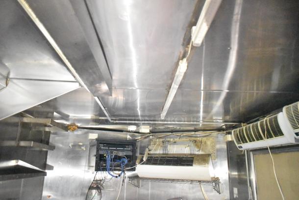 2019 Quality Cargo 24' food trailer interior, featuring grease hood, fryer, grill, and Blodgett oven. Fully equipped kitchen.