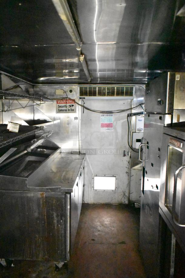 2019 Quality Cargo 24' food trailer interior, showing grease hood, fryer, grill, and Blodgett oven. Clean condition.