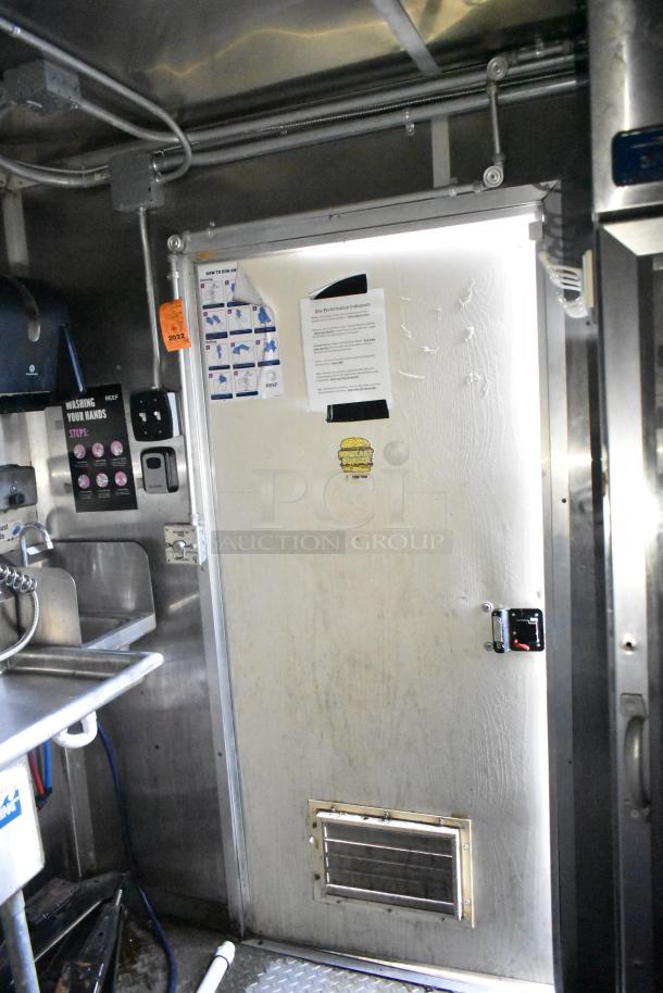Interior view of a 2020 Diamond Cargo 24' kitchen trailer featuring signs and labels indicating handwashing procedures.
