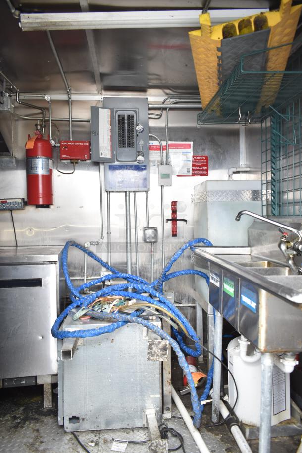 2020 Diamond Cargo 24' kitchen trailer interior with grease hood, Pitco fryer, Wells griddle, Arctic Air refrigeration setup.