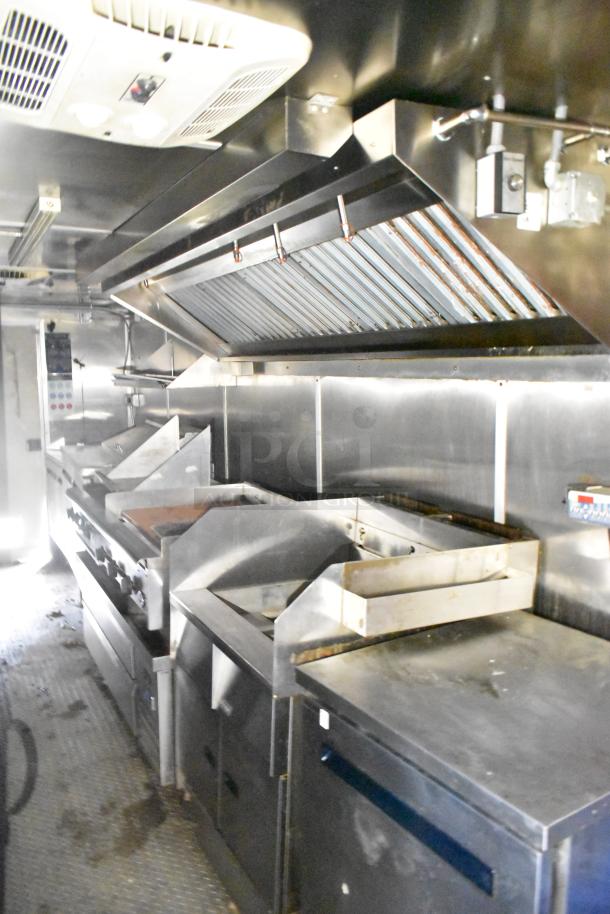 2020 Diamond Cargo 24' kitchen trailer interior; features grease hood, Pitco fryer, Wells dual griddle, Arctic Air refrigeration.