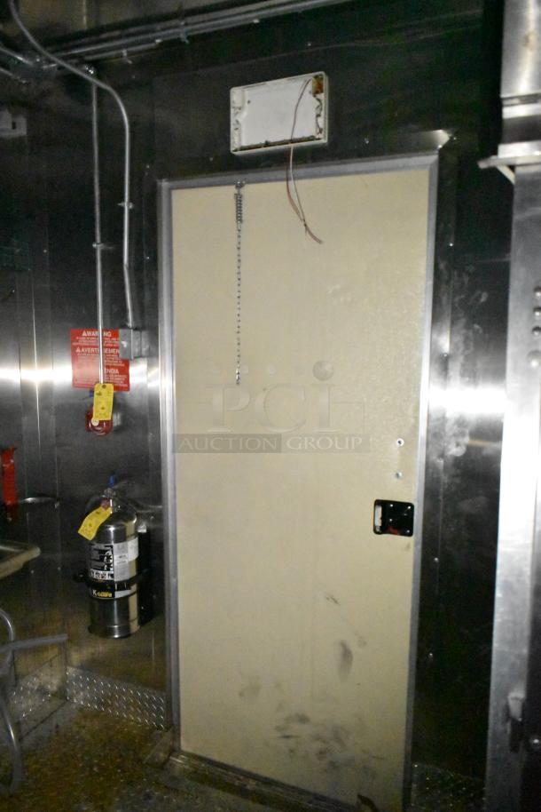 2021 Diamond Cargo 8.5x24 mobile kitchen trailer interior, fire extinguisher with tags visible, metal wall and wiring.