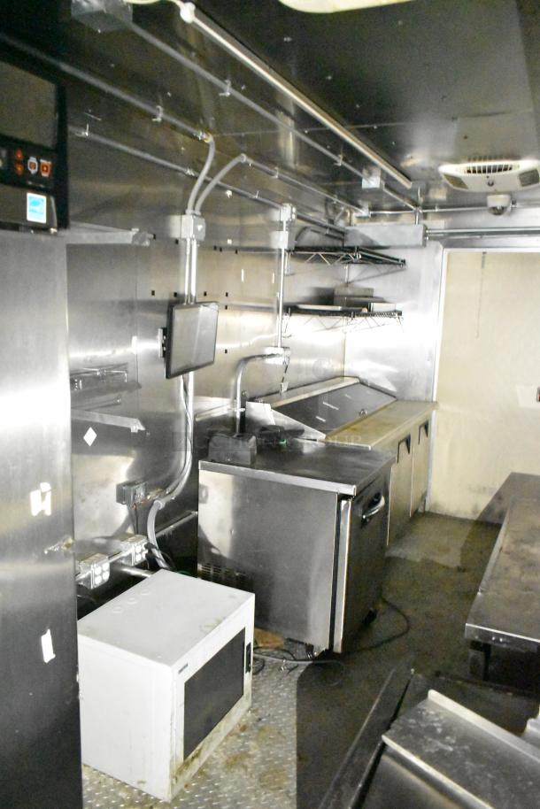 2021 Diamond Cargo 8.5x24 mobile kitchen trailer interior, featuring stainless steel surfaces, extensive refrigeration, and kitchen equipment including TurboChef ovens.
