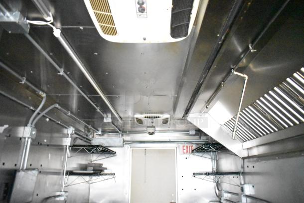 Interior of 2021 Diamond Cargo Mobile Kitchen Trailer with Econ-Air hood, wire shelving, and ventilation system.