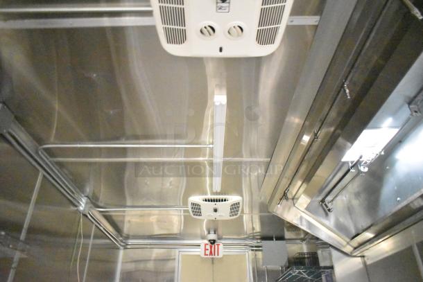 Interior of a 2021 Diamond Cargo kitchen trailer. Features Paragon hood, wiring, and EXIT sign. Like-new condition.
