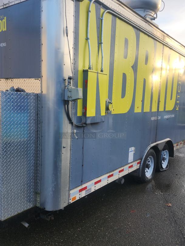 2018 16' Quality Cargo food trailer, metallic exterior, visible utility hookups, professional branding on side.