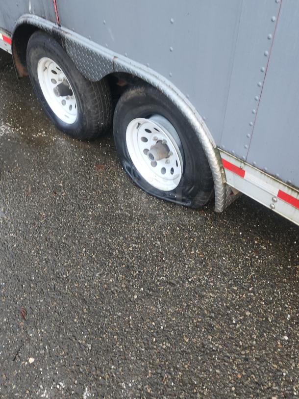 2018 Quality Cargo 16' food trailer with dual axles, in need of tire repair. Exterior showcases robust utility design.