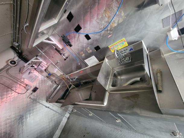 2018 Quality Cargo 16' food trailer interior, featuring stainless steel counters, sink, and commercial kitchen equipment.