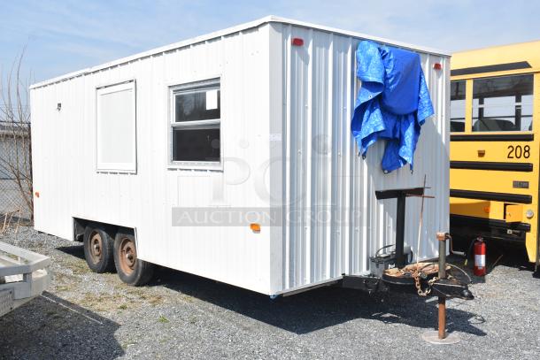 Unbranded food trailer with white paneling, Diehard 27DC-2 battery, Eaton power box, interior counters, and ventilation fan.