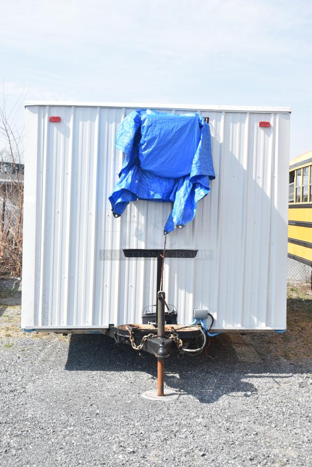 Unbranded food trailer with Diehard 27DC-2 battery, Eaton power box, counter, and ventilation fan. White exterior, covered.