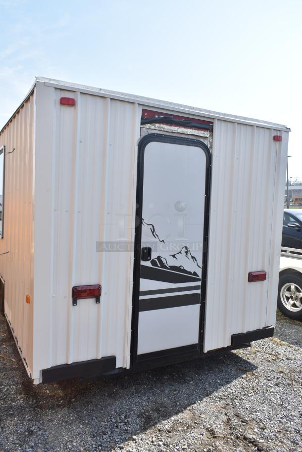 Unbranded food trailer with graphic door, equipped with Diehard 27DC-2 battery, Eaton power box, counter, and ventilation fan.