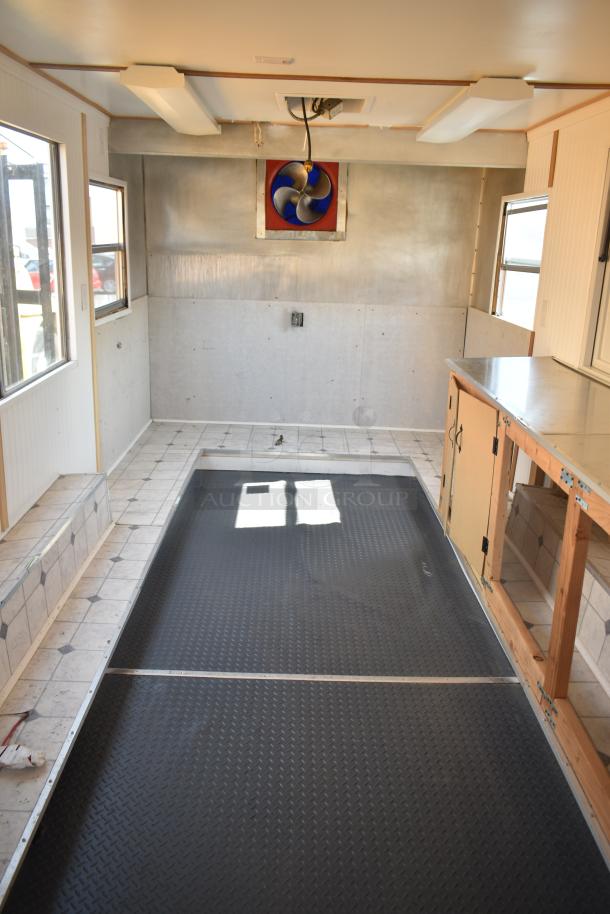 Unbranded food trailer interior with Eaton power box, Diehard 27DC-2 battery, counter, and ventilation fan.