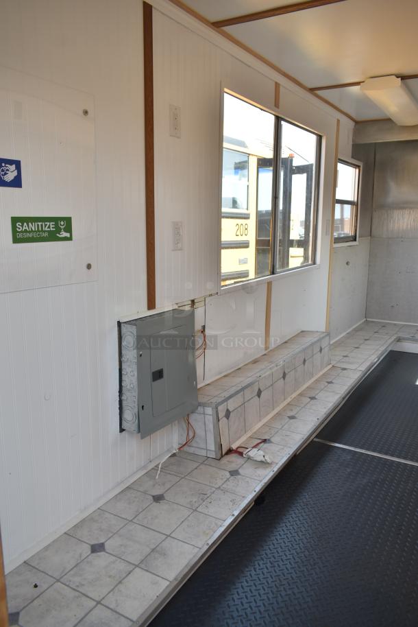 Unbranded food trailer interior with Eaton power box, Diehard 27DC-2 battery setup, counter space, and ventilation fan.