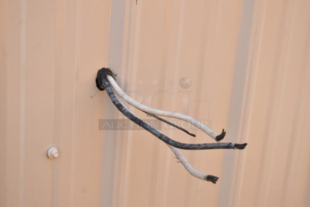 Unbranded food trailer exterior with protruding electrical wires. Image focuses on wiring, necessary for powering the Diehard 27DC-2 battery and Eaton power box inside.