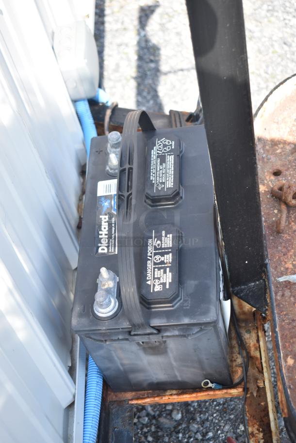 Diehard 27DC-2 battery in food trailer; visible labels and connections, part of unbranded unit with Eaton Power Box.