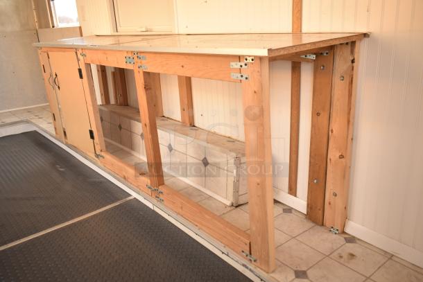 Unbranded food trailer interior with wooden counter, storage space, and ventilation fan. Includes Diehard 27DC-2 battery and Eaton power box.