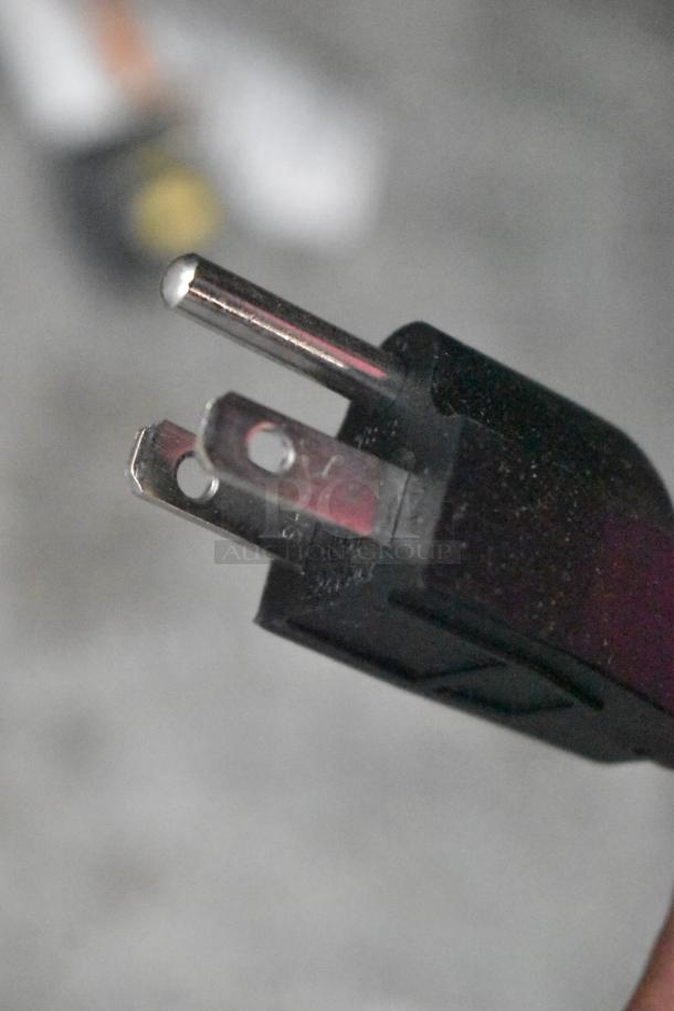 Close-up of a power plug, slightly scratched, part of a Waring WSM20LT commercial dough mixer, 110-120V, 2024 model.