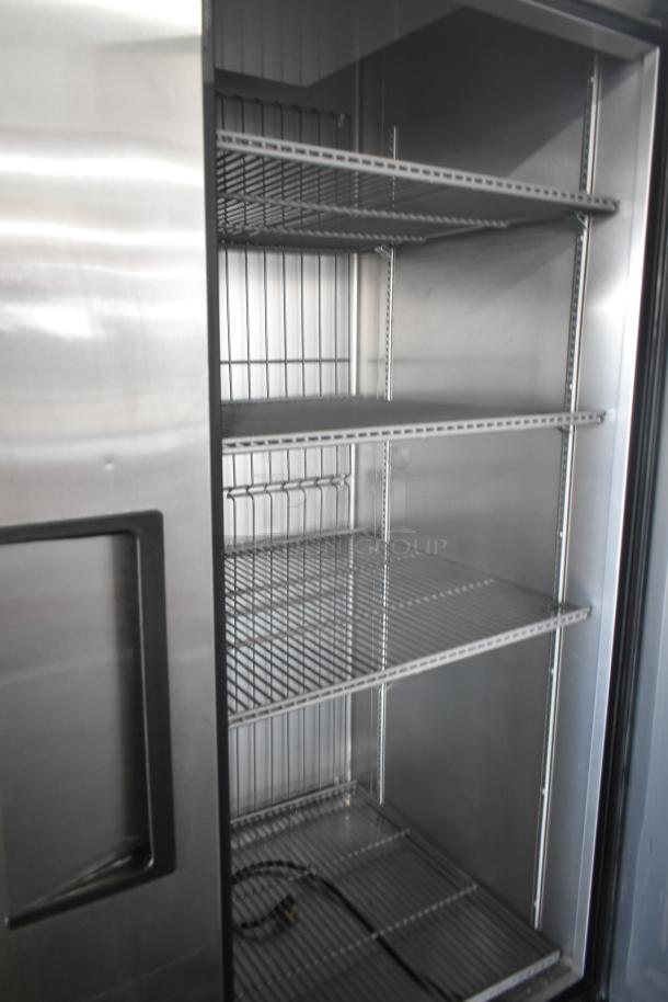 2020 True T-49F-HC Commercial 2 Door Reach-In Cooler, stainless steel, on casters, with adjustable wire shelves.
