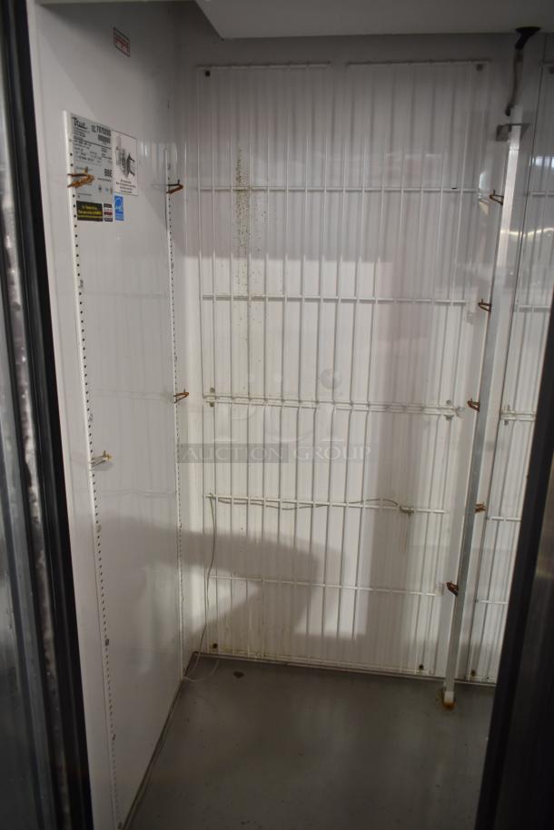 True GDM-49F-LD 2-door reach-in freezer, white interior with wire shelves, labels indicate model and voltage, moderate wear.