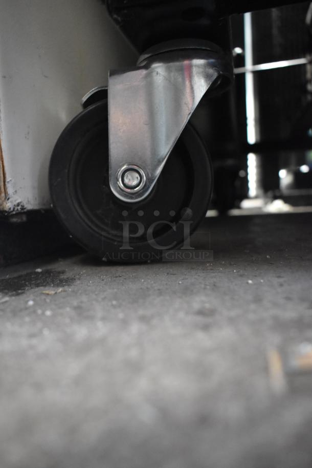 Close-up of a commercial caster from a 2019 True T-49F-HC 2-door reach-in freezer, showcasing durable construction.