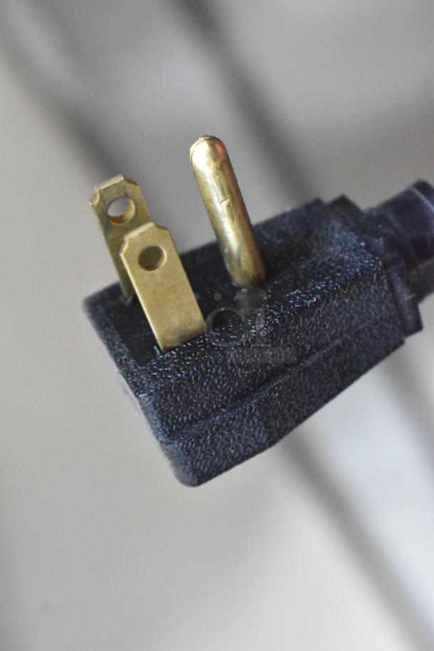 Close-up of a three-prong electrical plug for a 2020 True T-49F-HC commercial freezer.
