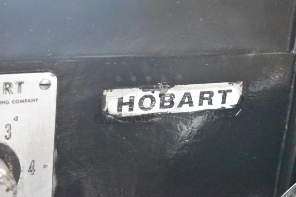 Hobart L800 commercial mixer label, showing wear. Features include an 80 qt mixing bowl, paddle, whisk, and dough hook.