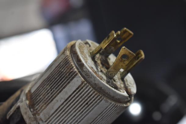 Close-up of a worn electrical plug for a Hobart L800 mixer, showing metal prongs and a ribbed exterior grip.