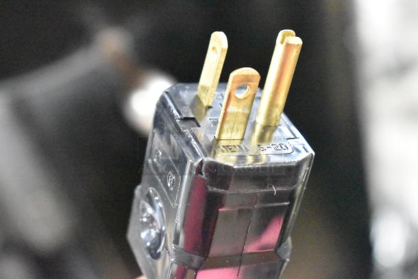 Close-up of a plug for a Unic CL1 Classic Commercial Espresso Machine, showing three prongs and markings.