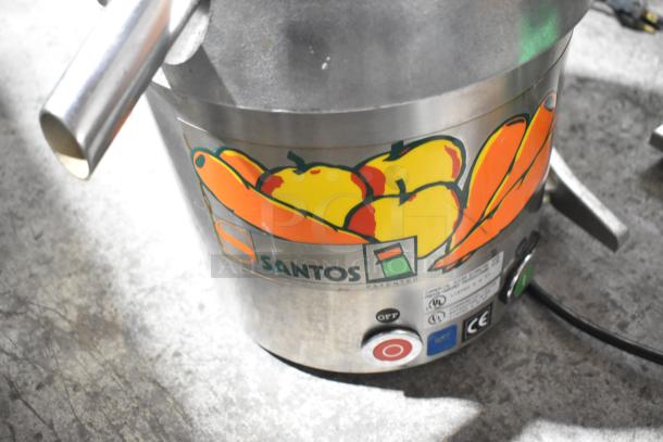 Santos Commercial Countertop Juice Extractor, 115V, 1 Phase. Stainless steel body with fruit decal. Power button visible.