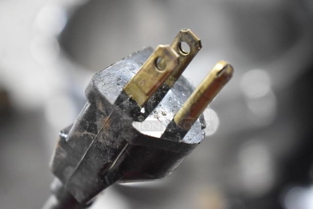 "Close-up of plug for Santos commercial countertop juice extractor, 115 volts, 1 phase. Slight wear visible."