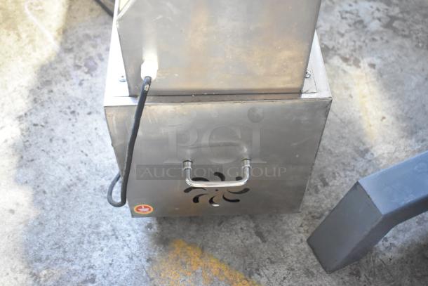 Stainless steel electric vegetable cutting machine; multifunctional, commercial-grade, mounted on casters, handle and power cable visible.