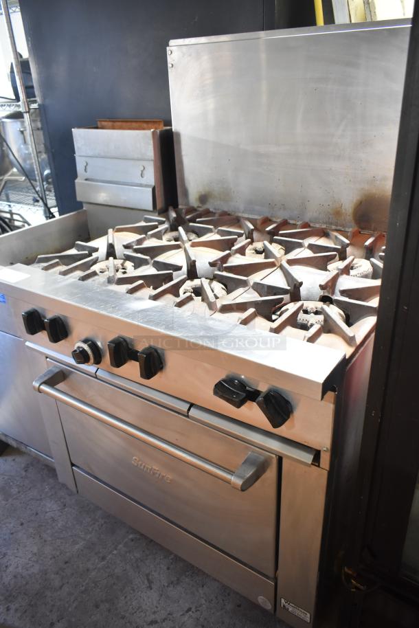 Garland X36-6R SunFire stainless steel commercial range with 6 burners, oven, overshelf, and backsplash. Natural gas-powered.