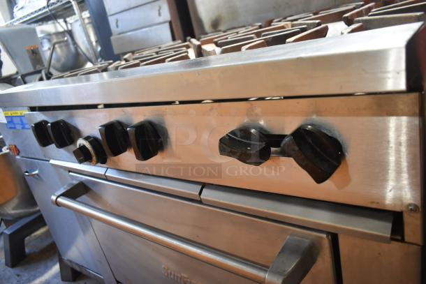Garland X36-6R SunFire stainless steel 6-burner commercial gas range with oven, over shelf, and backsplash. Good condition.