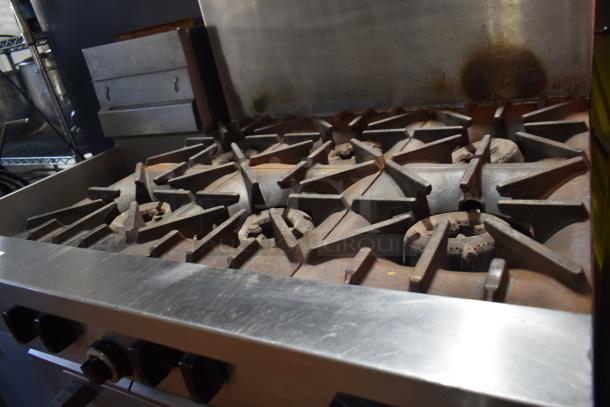 Garland X36-6R SunFire 6-burner stainless steel range, natural gas, with oven, shelf, and backsplash, used condition.